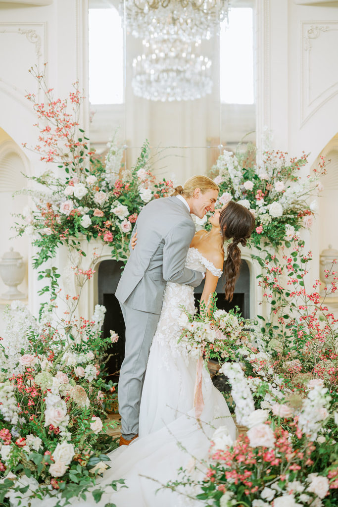 bride and groom surrounded by flowers