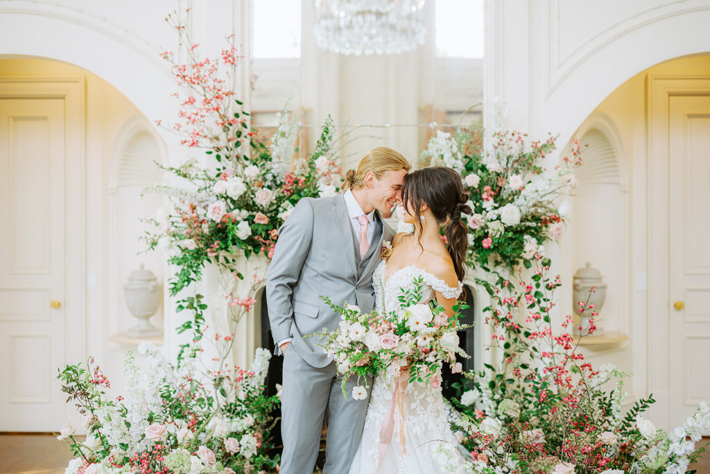 bride and groom surrounded by florals